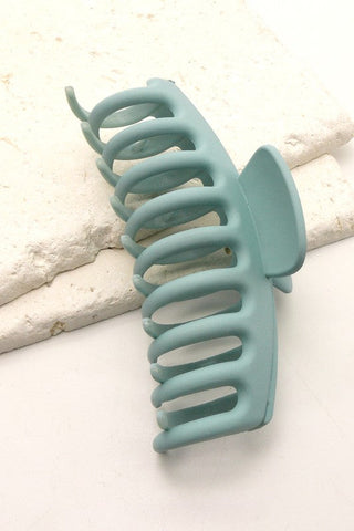 a plastic claw clip in blue colour