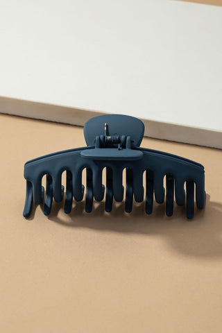 a plastic claw clip in a blue colour
