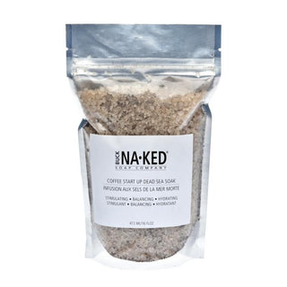 A clear plastic pouch packaging of Coffee Start Up Dead Sea Salt soak with a label that includes product name and benefits, such as 'Hydrating' and 'Detoxifying'.