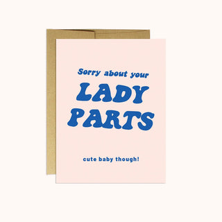 A greeting card with blue writing on pink paper. 
