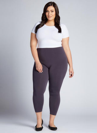 A woman wearing Curvy bamboo 3/4 leggings and a white tee. 