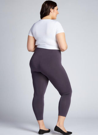 A woman wearing Curvy bamboo 3/4 leggings and a white tee. 
