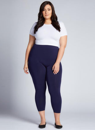 A woman wearing Curvy bamboo 3/4 leggings and a white tee. 