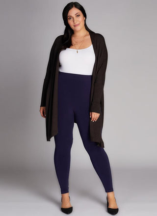 A model wearing black bamboo curvy full-length leggings. 