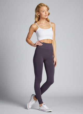 A woman is standing wearing bamboo high-waisted leggings. 