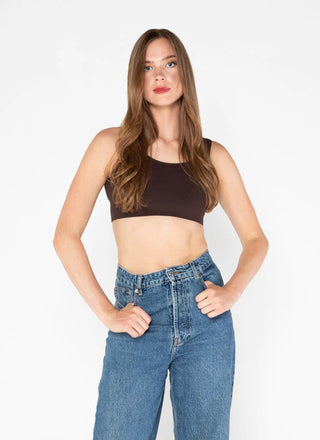 A woman wearing a bamboo bralette with jeans . 