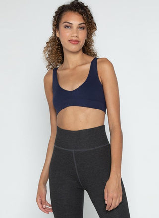 A woman wearing a bamboo bralette leggings. 