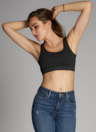A woman wearing a bamboo bralette jeans.