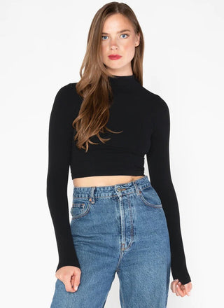 a women wearing a crop black long sleeve mock neck top made of bamboo