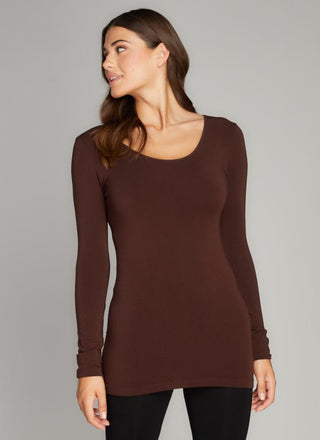 A woman wearing a long sleeve scoop neck top in brown. 