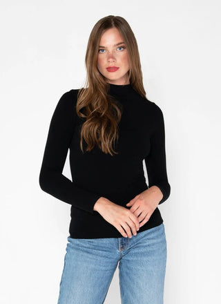 Woman wearing a black mock neck top made of bamboo