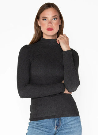 Woman wearing a grey mock neck top made of bamboo