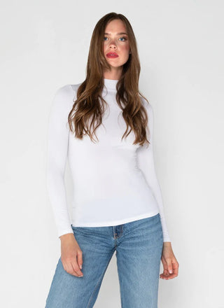 Woman wearing a white mock neck top made of bamboo