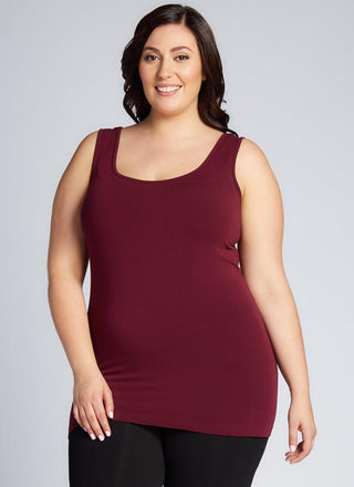 A woman wearing a Bamboo Curvy Classic Tank Top with thick straps and a scoop neckline.