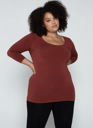 A woman wearing a Curvy bamboo 3/4 sleeve top. 