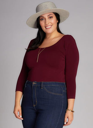 A woman wearing a Curvy bamboo 3/4 sleeve top. 