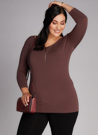 A woman wearing a Curvy bamboo 3/4 sleeve top. 