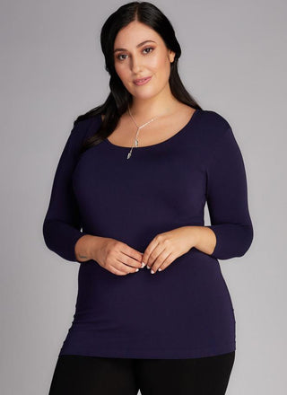 A woman wearing a Curvy bamboo 3/4 sleeve top. 