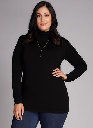 A plus-size model wearing a black bamboo curvy turtleneck top.