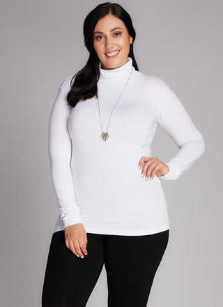 A plus-size model wearing a white bamboo curvy turtleneck top.