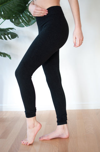 A woman is standing wearing bamboo heathered leggings. 
