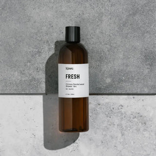 Brown bottle with a white label on a gray concrete background