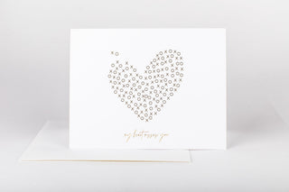 A greeting card with a gold foil embossed heart design and the text 'I miss you' on it, accompanied by a white envelope.