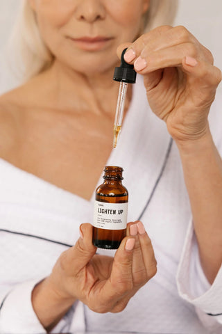 women using the lighten up serum from k'pure. a brightening serum