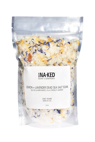 A clear plastic package containing lemon and lavender dead sea salt soak with a white label that reads 'Naked Soap Company, Lemon & Lavender Salt Soak, 100% Natural, 200g'.
