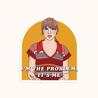 A sticker with a illustration of a white cat with a bow, and the text 'I'm the problem it's me"