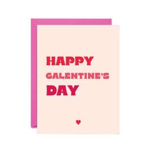 Card with text printed on it saying Happy Galentine's Day in red and pink block letters. 