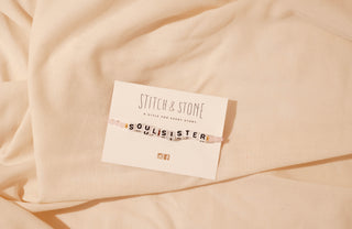 Stitch & Stone label on a beige fabric background
