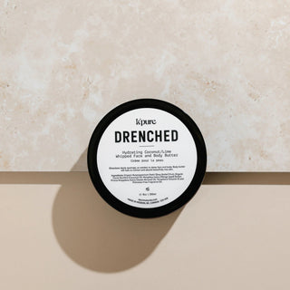 K'pure Drenched whipped face and body butter container on a beige background
