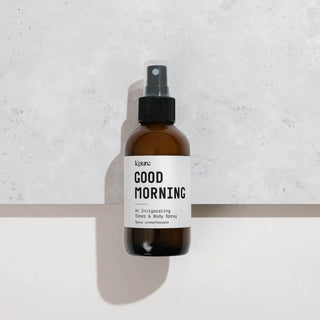 Brown spray bottle labeled 'Good Morning' on a light gray background