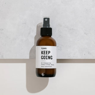 Brown spray bottle with a white label on a light gray background