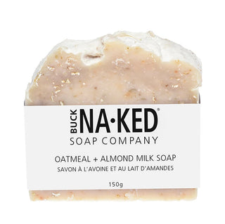 A bar of oatmeal and almond milk soap with a label that reads 'BUCK NAKED SOAP COMPANY OATMEAL & ALMOND MILK SOAP 150g'.